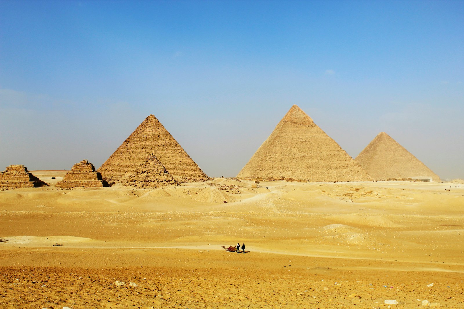 Pyramids rising from the Egyptian desert under an open sky