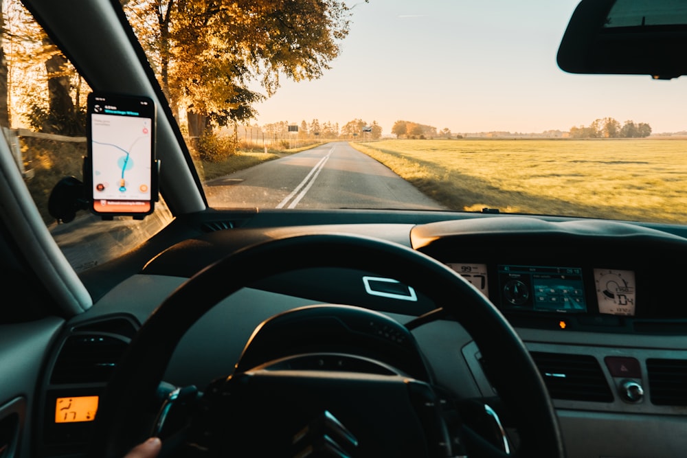 a person driving a car on a country road