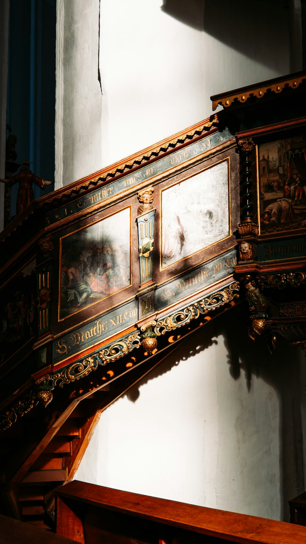 an ornate wooden shelf with paintings on it