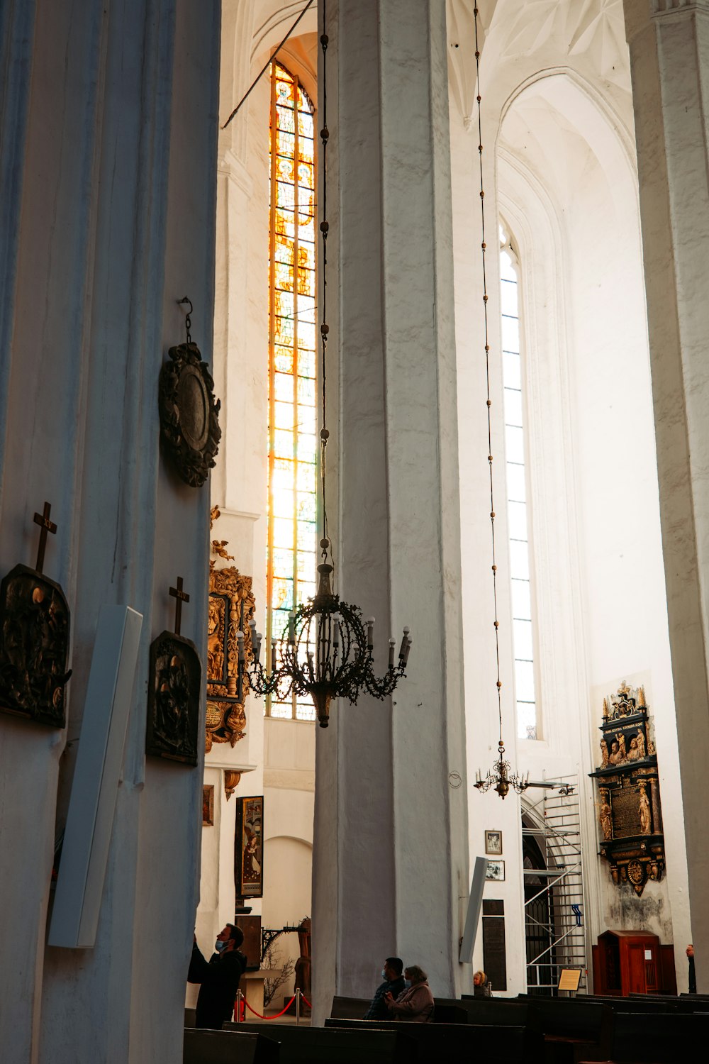 a group of people in a church with stained glass windows