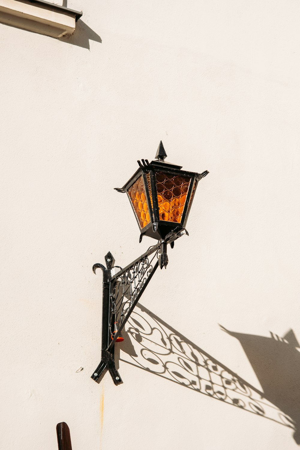 a street light casting a shadow on a wall