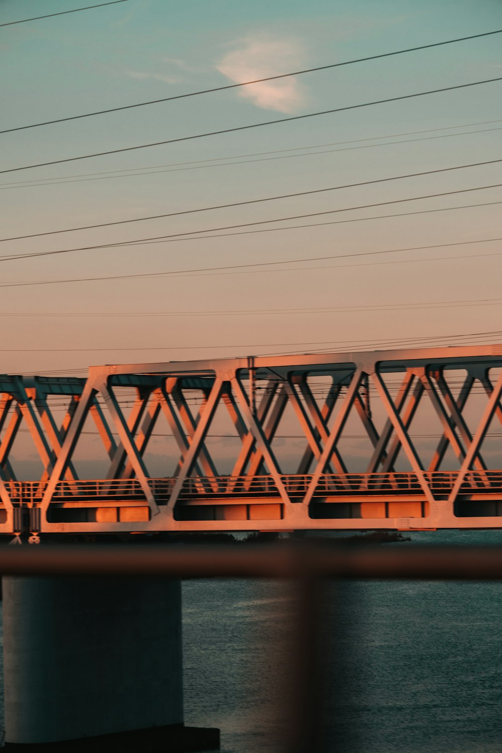 a train crossing a bridge over a body of water