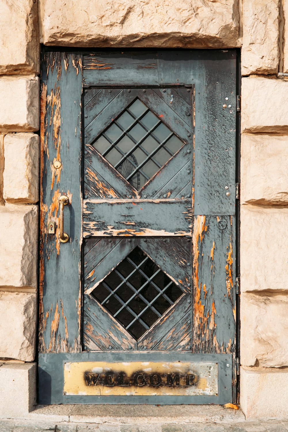 a blue door with a window on the side of a building