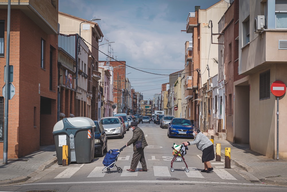 a group of people walking across a street