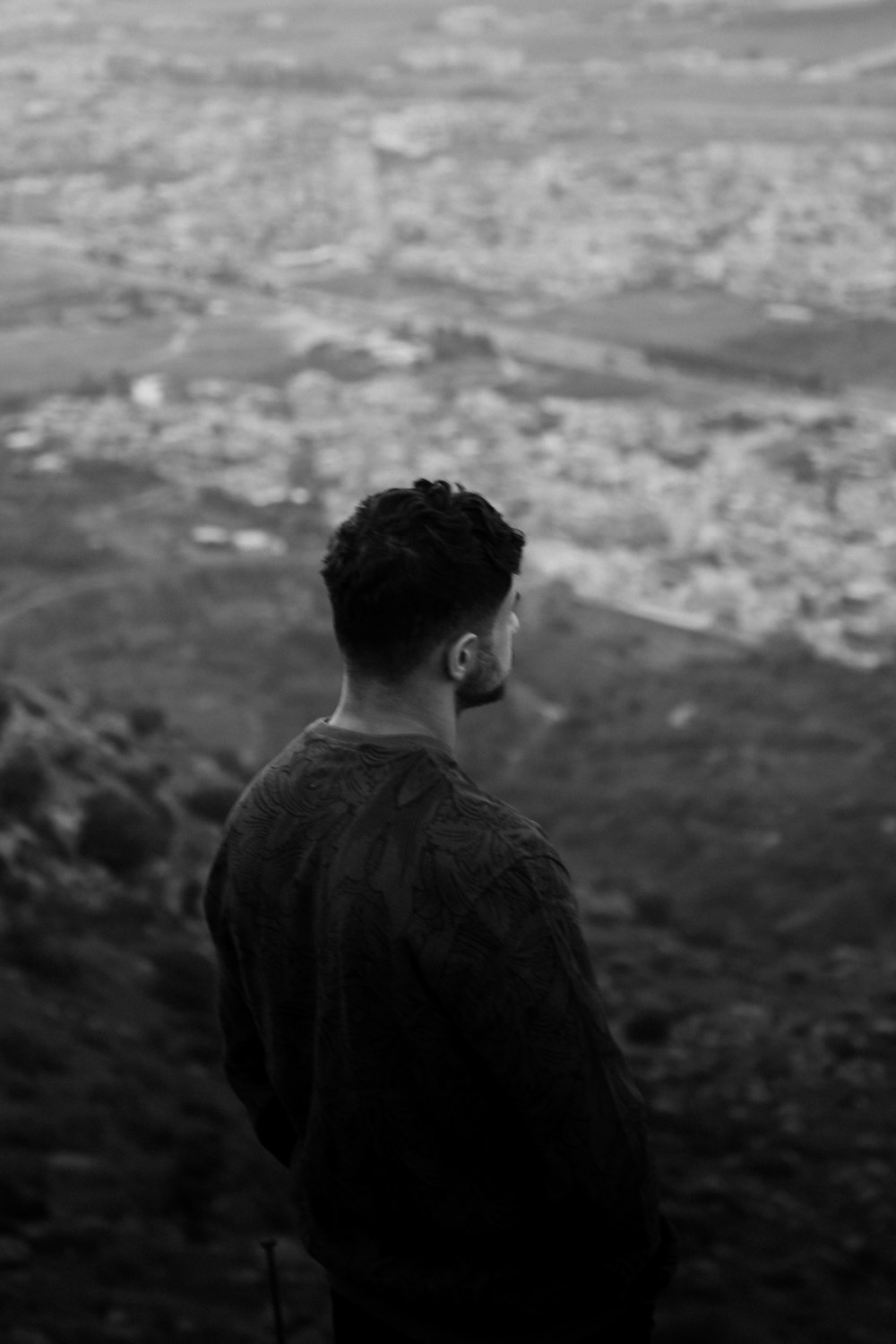 a man standing on top of a hill overlooking a valley