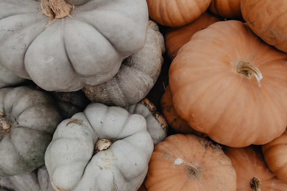 a pile of pumpkins sitting next to each other