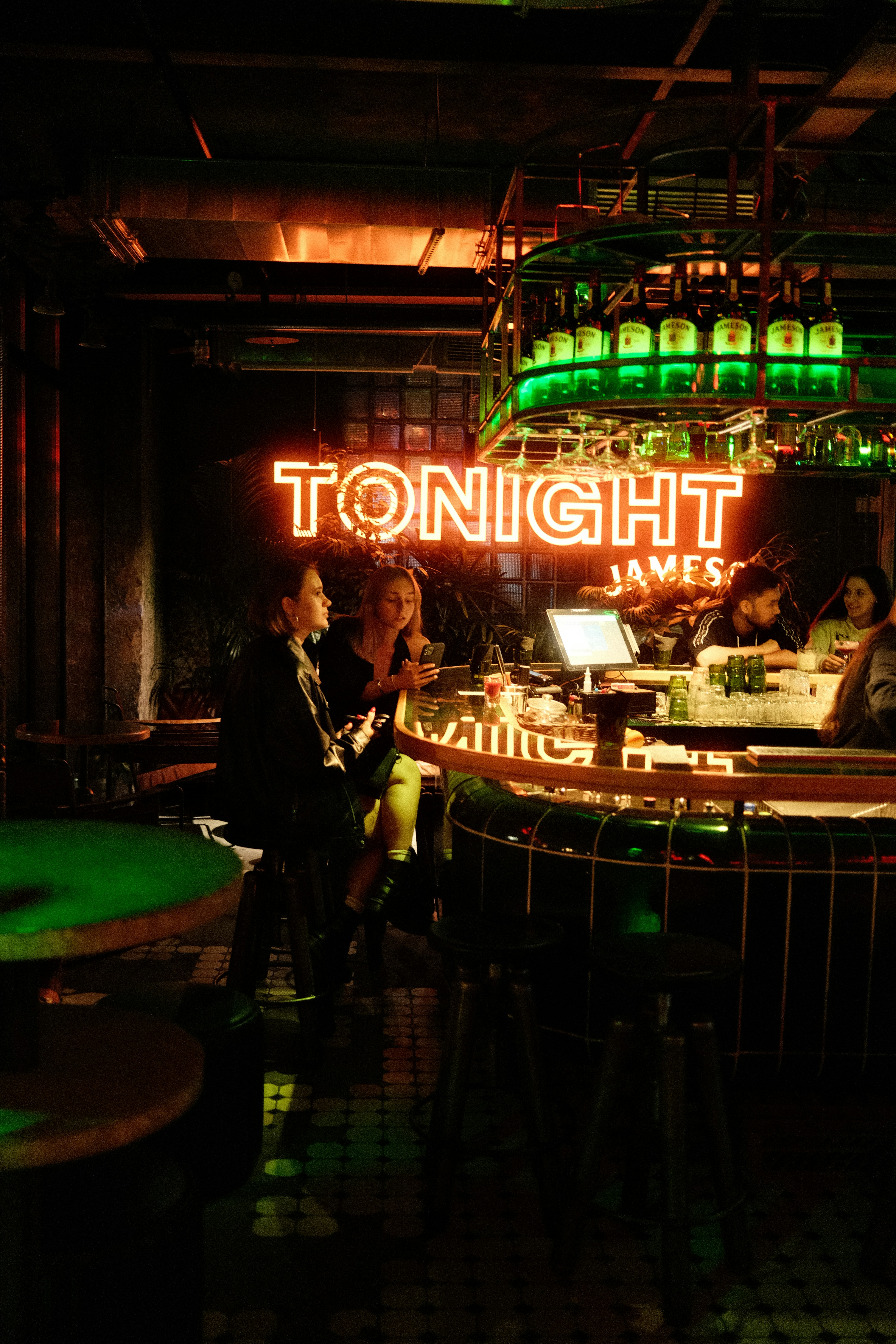 a group of people sitting at a bar