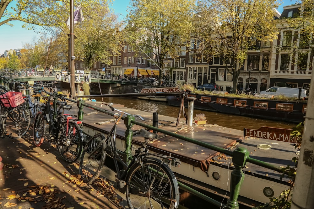 a row of bikes parked next to a river