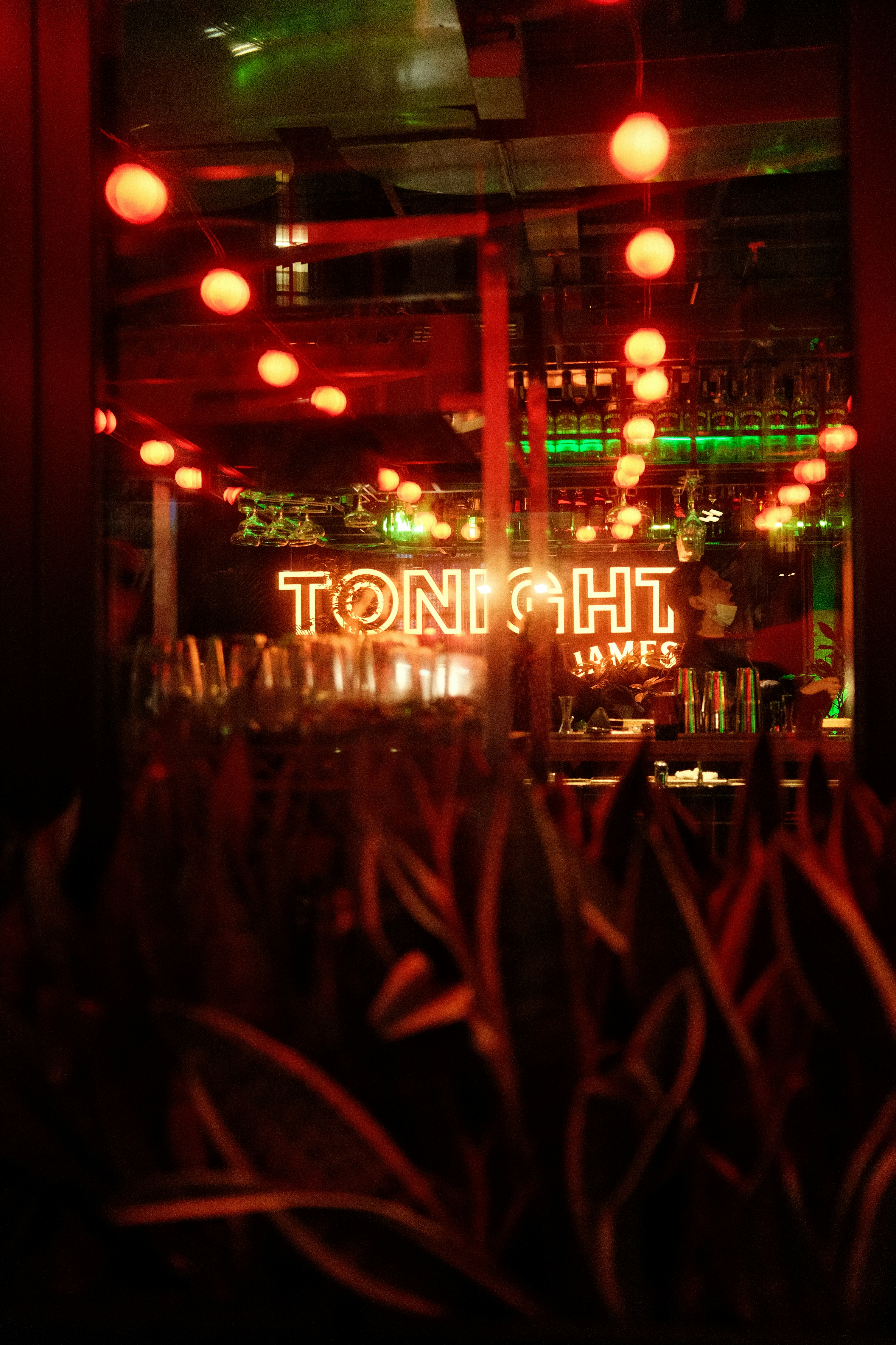 a view of a restaurant through a window at night