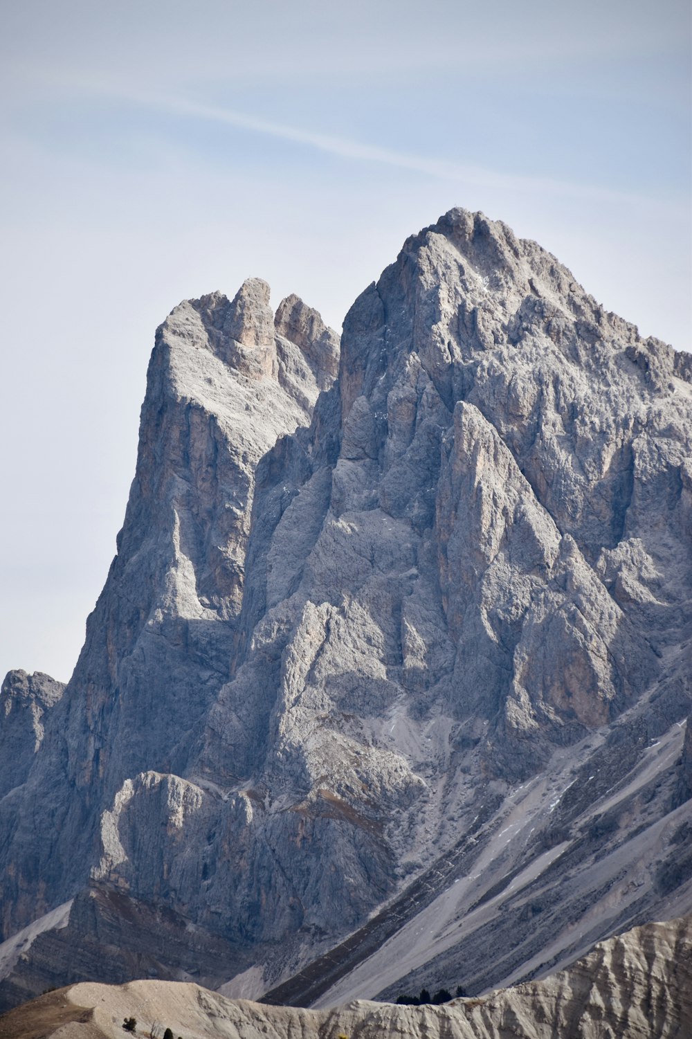 a very tall mountain with a sky in the background