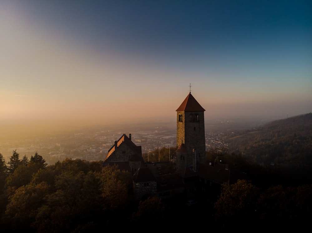 a church on top of a hill surrounded by trees