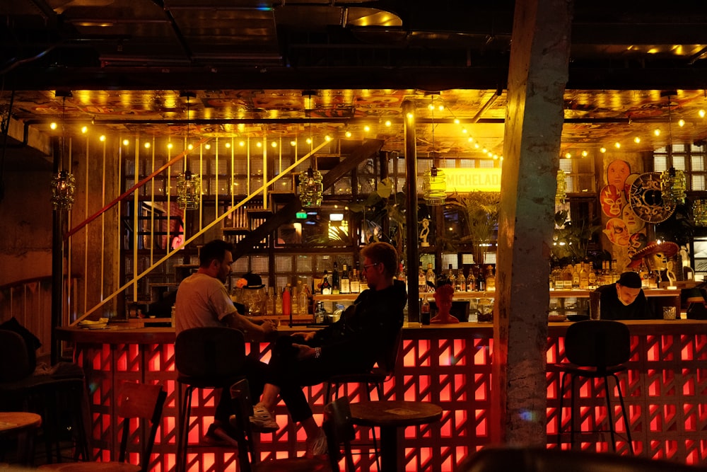 a group of people sitting at a bar