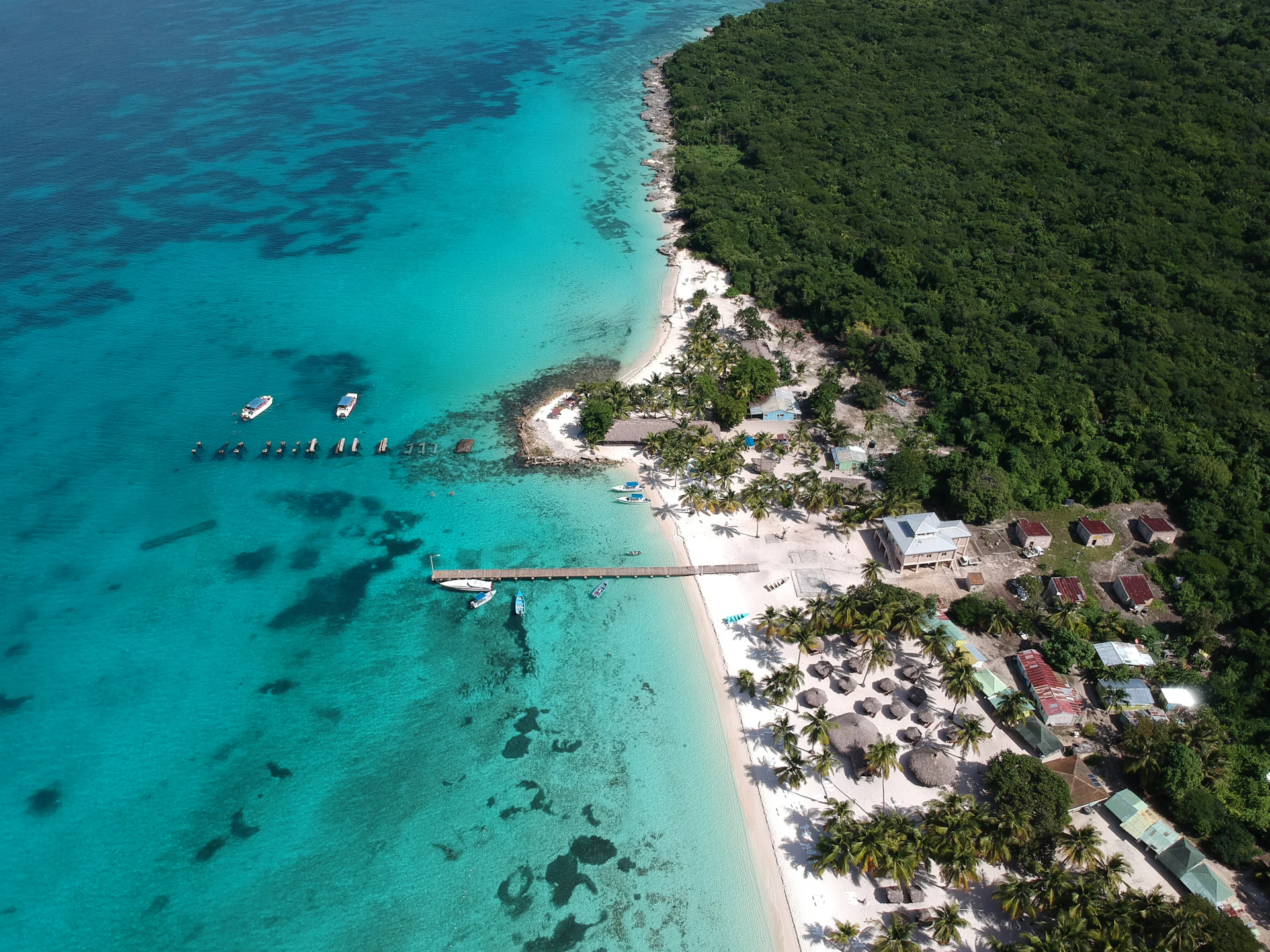 Aerial view of a tropical island with boats in the Dominican east