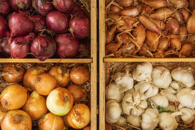 A vibrant display of fresh onions stacked in wooden crates.