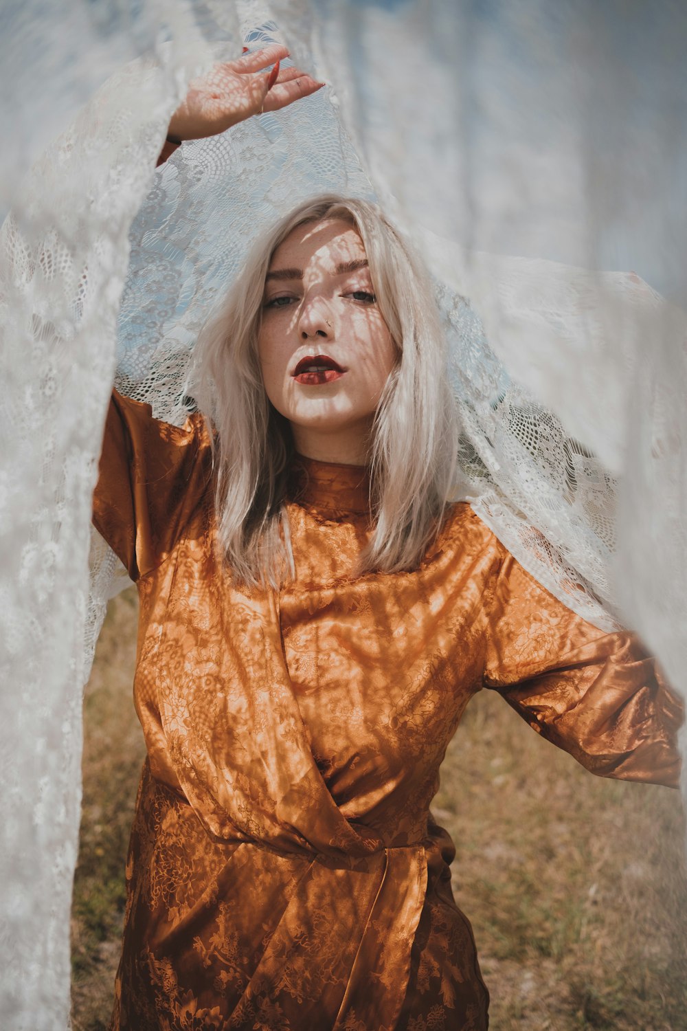 a woman with white hair and a veil on her head