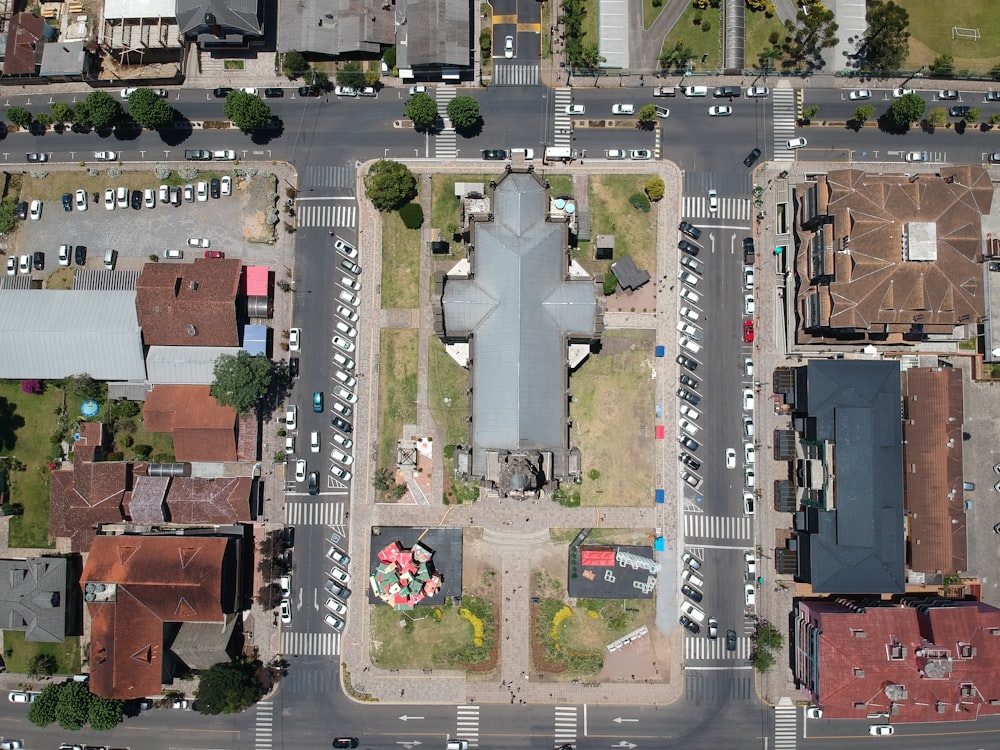 an aerial view of a parking lot with a plane in the middle of it