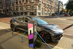 a car plugged into a charging station on a city street