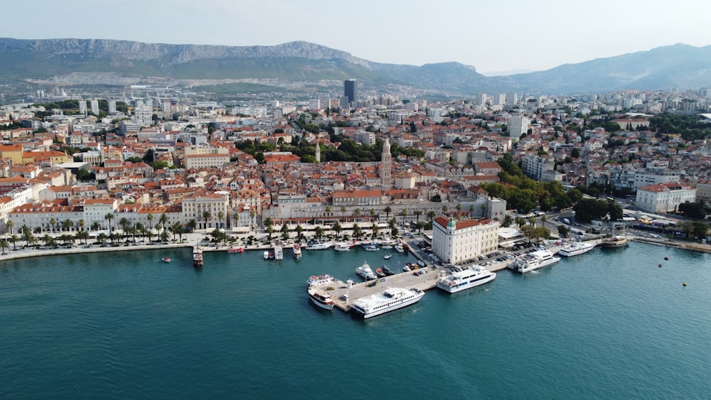 an aerial view of a city with boats in the water