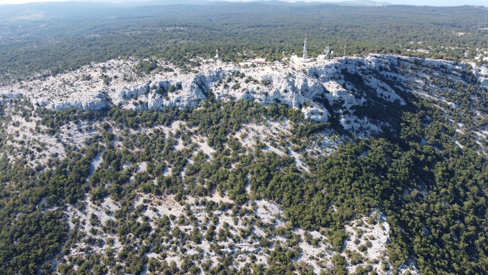 an aerial view of a mountain covered in snow