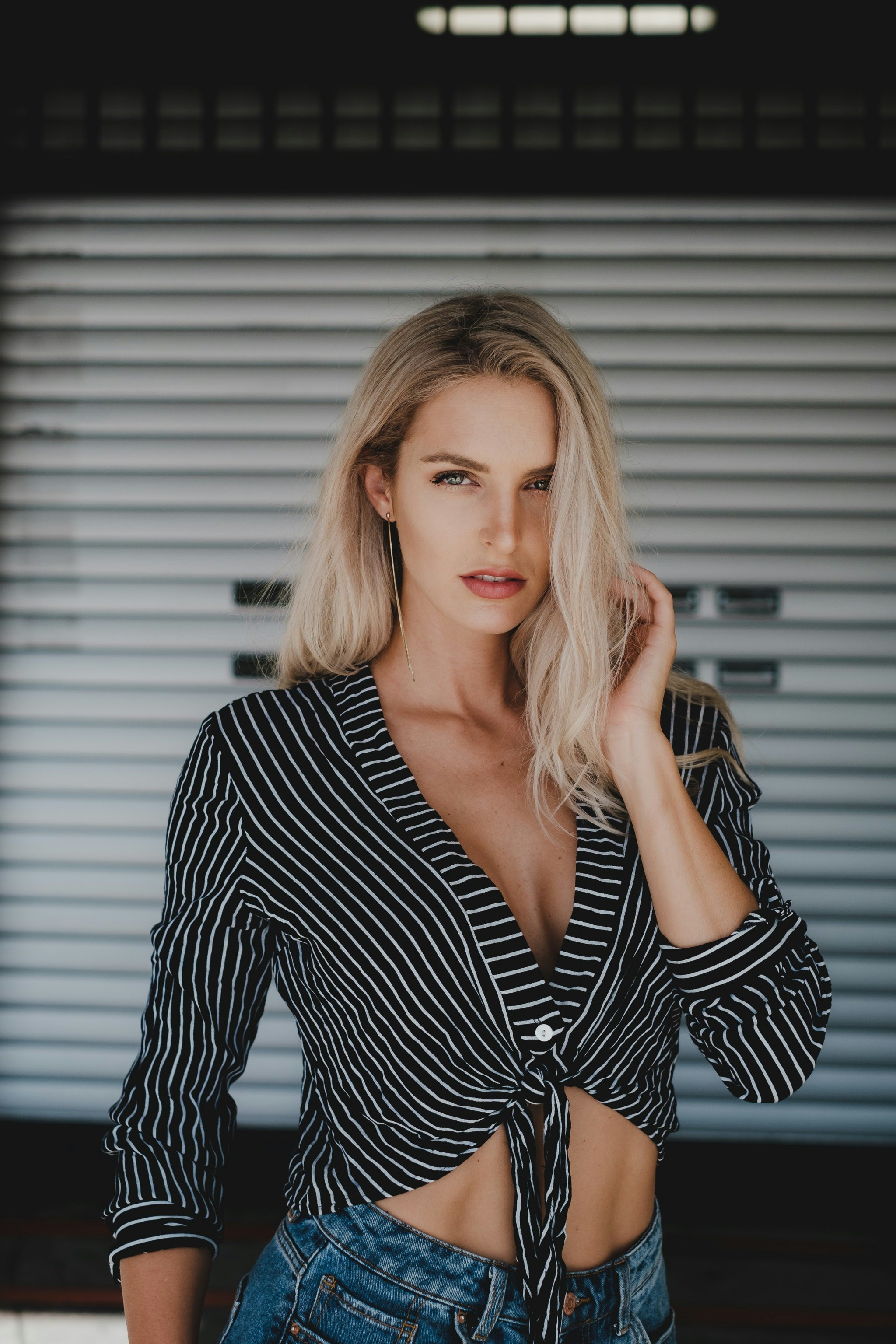 a woman wearing a black and white striped shirt