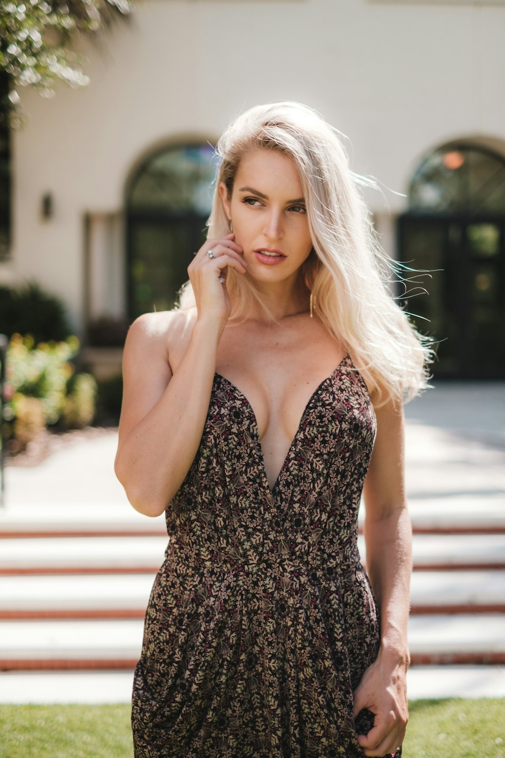 a woman in a floral dress posing for a picture