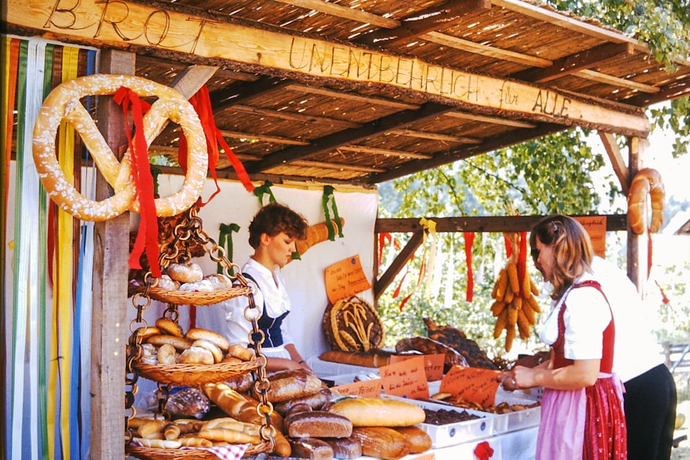 a couple of people that are standing in front of some food