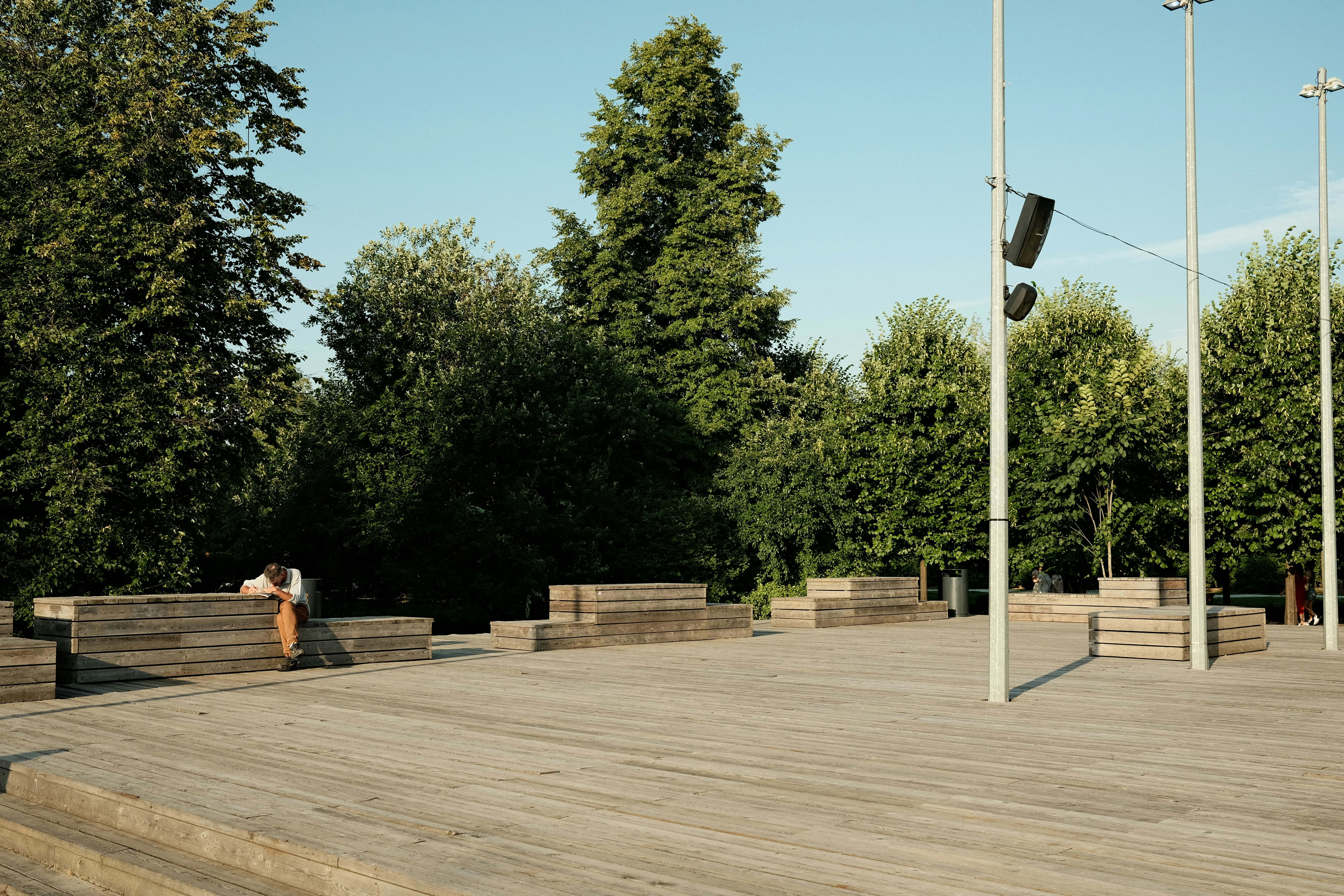 a person standing on a wooden deck with a skateboard
