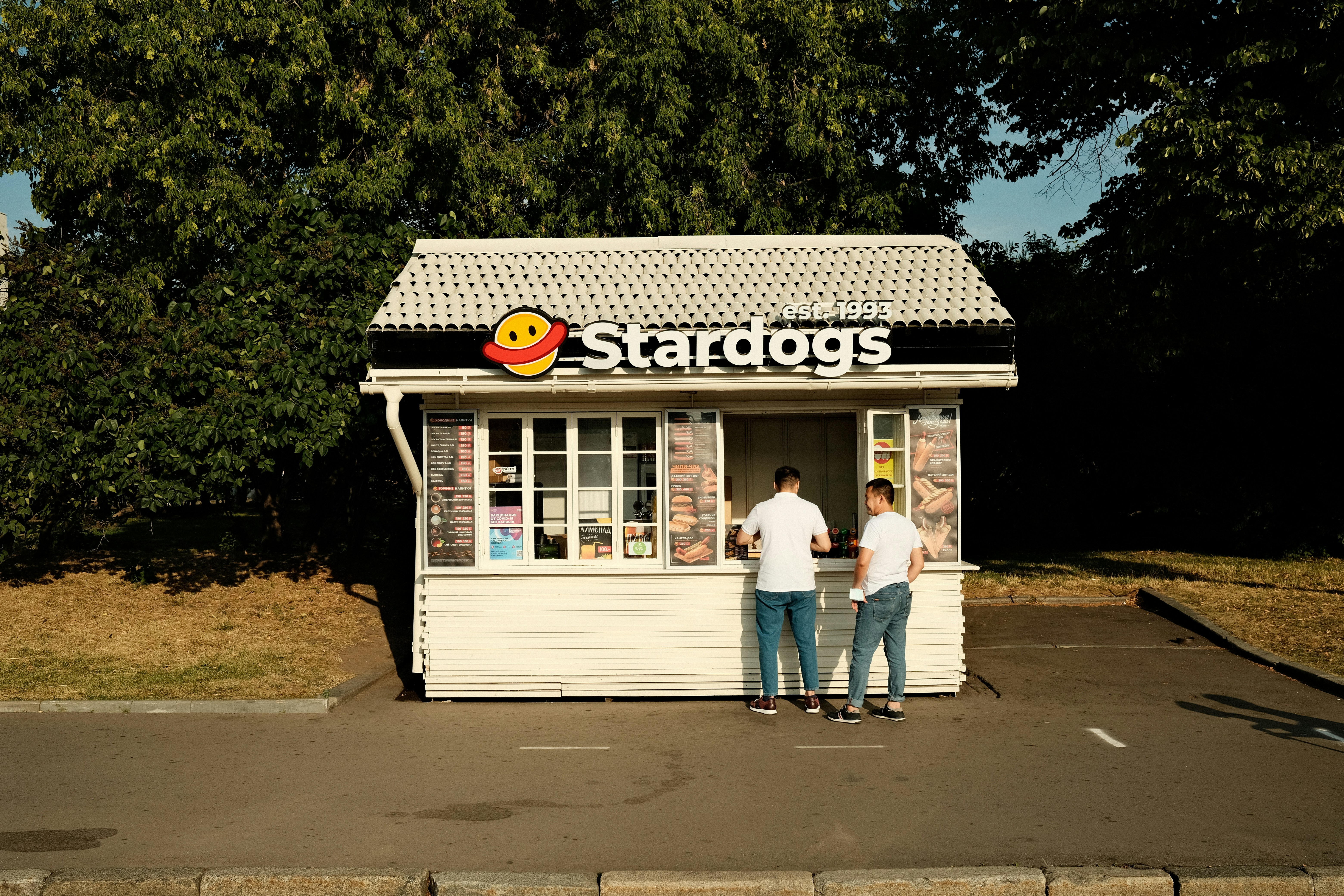 a couple of people standing outside of a store