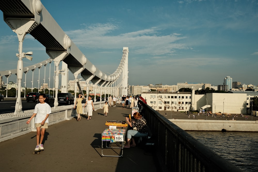 a man riding a skateboard across a bridge