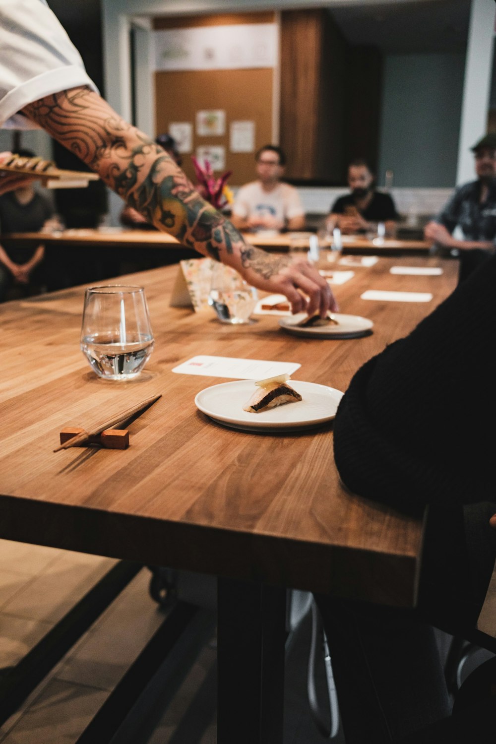 a group of people sitting around a wooden table