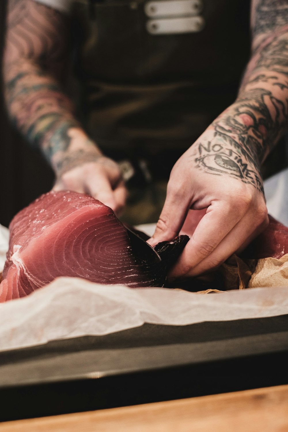 a man cutting up a piece of meat with a knife