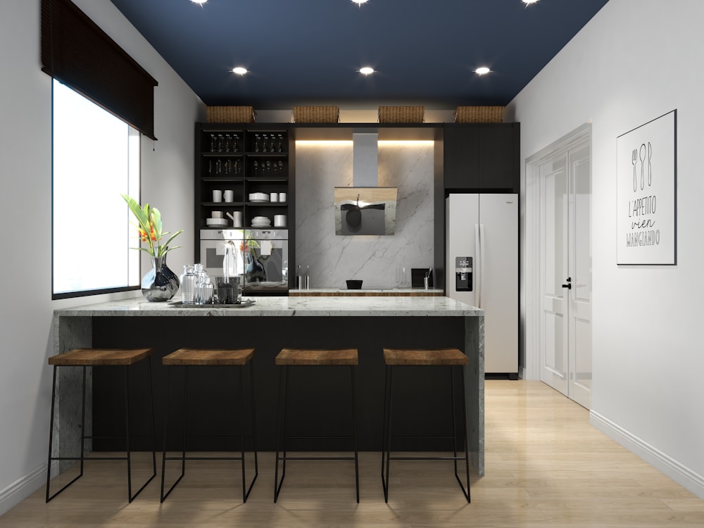 a kitchen with a center island and bar stools