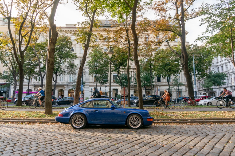 a blue car parked on the side of a road