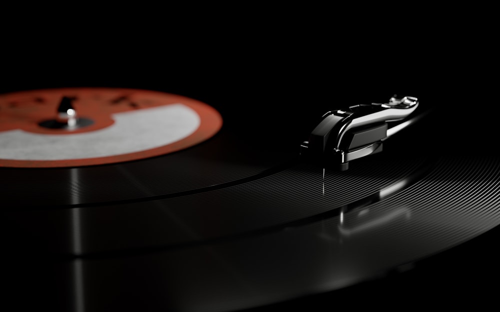 a turntable with a black background and a red and white disc
