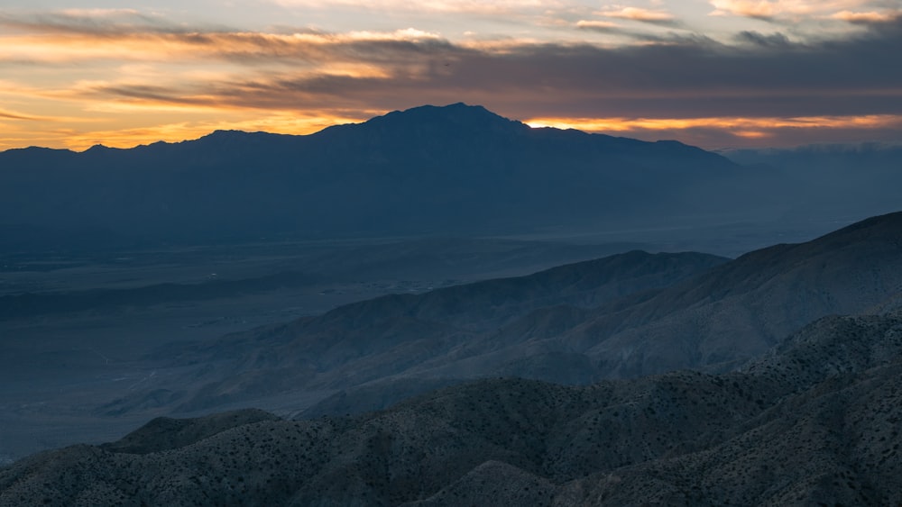 a view of a mountain range at sunset