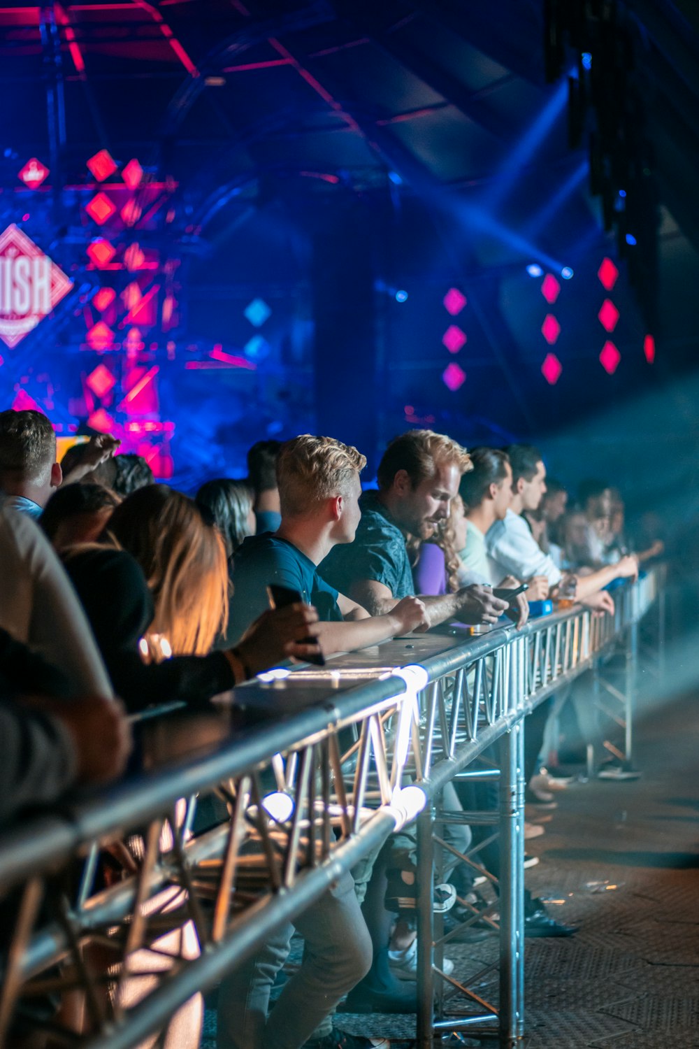 a group of people sitting at a table in front of a crowd