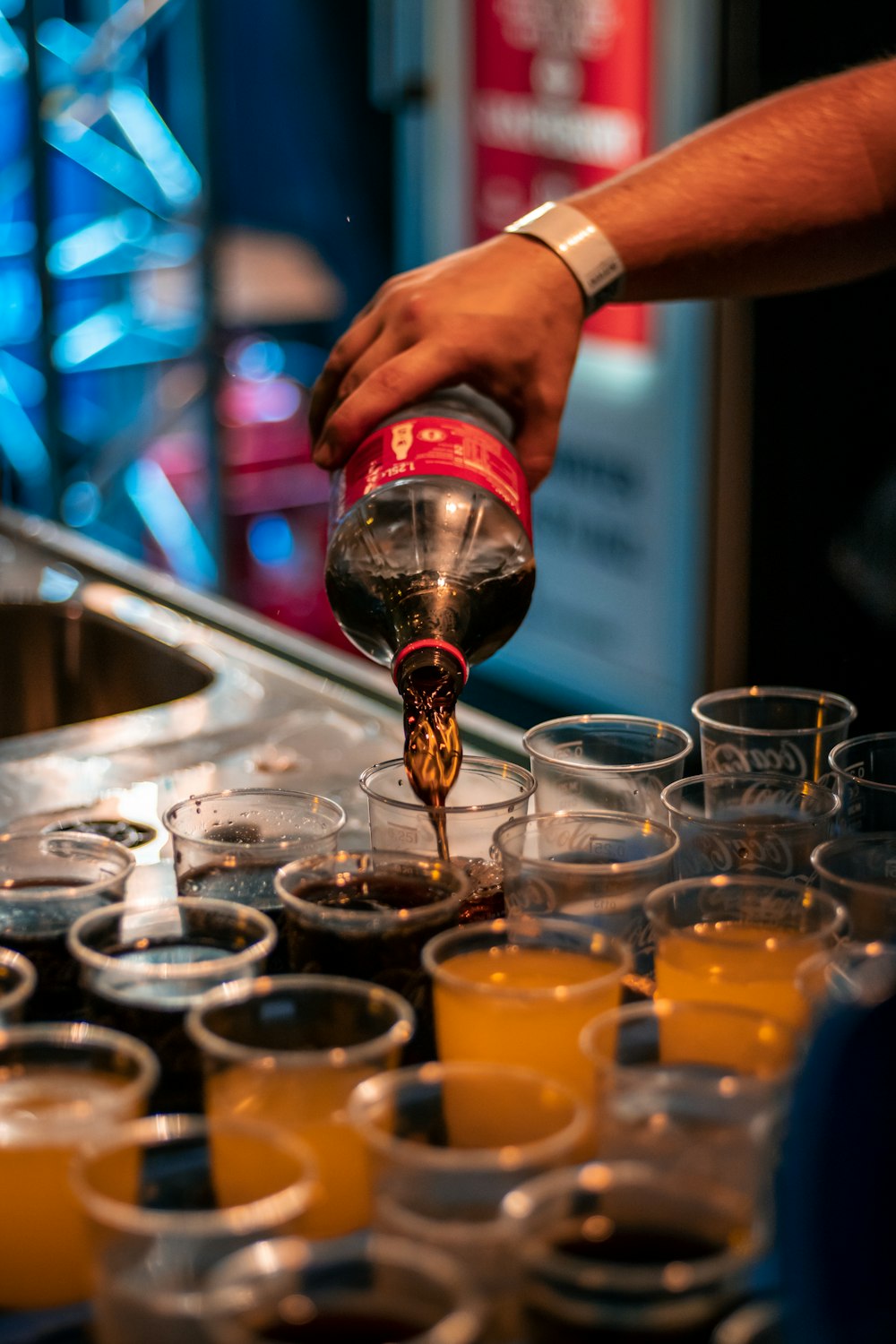 a person pours a beverage into a glass