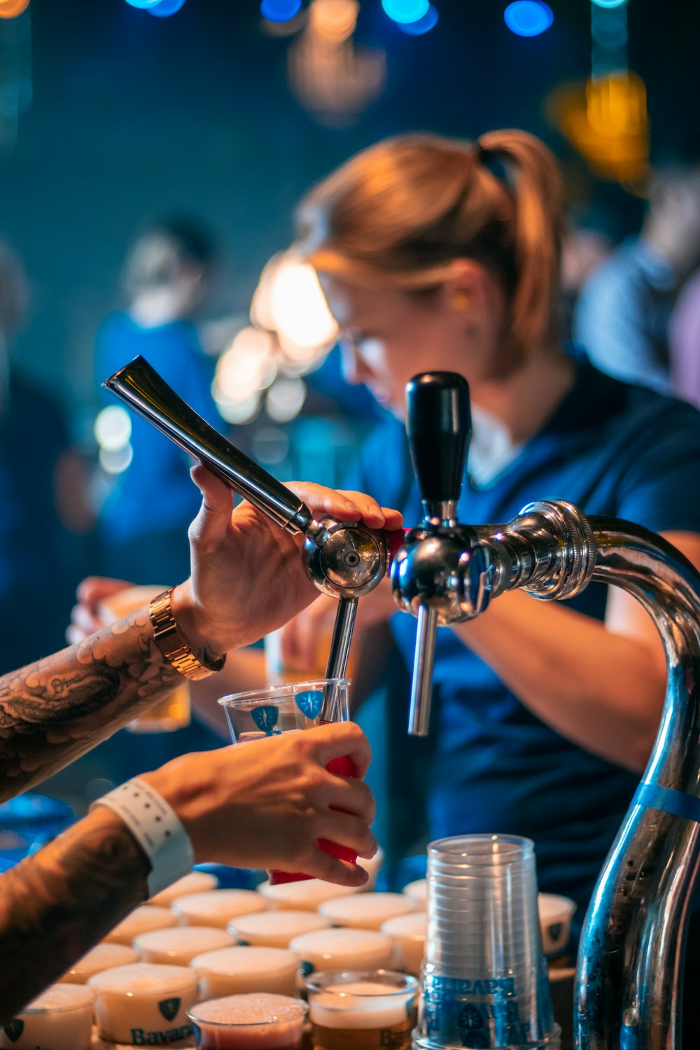 a group of people standing around a bar