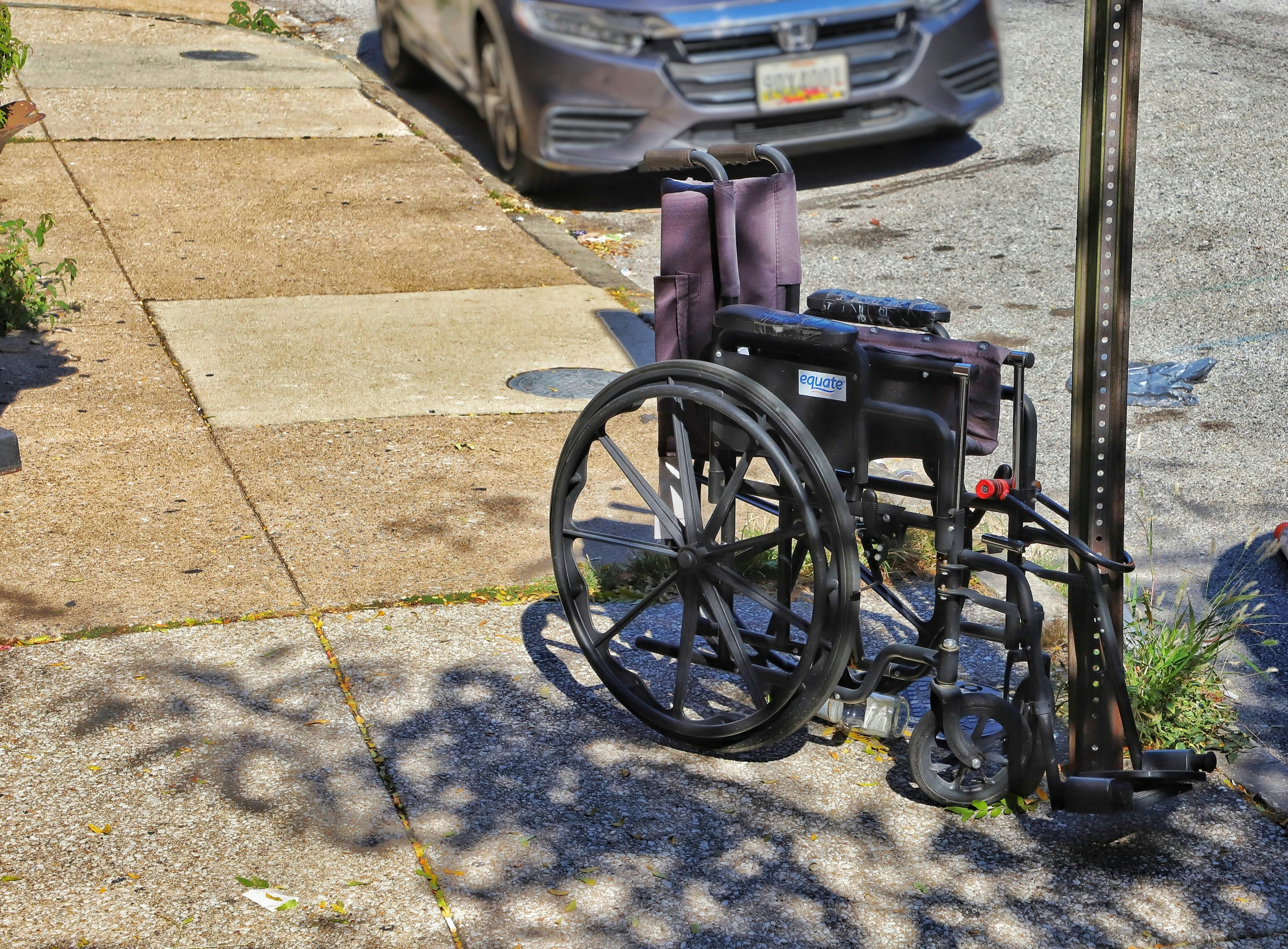 a wheelchair parked on the side of the road