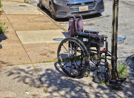 a wheelchair parked on the side of the road