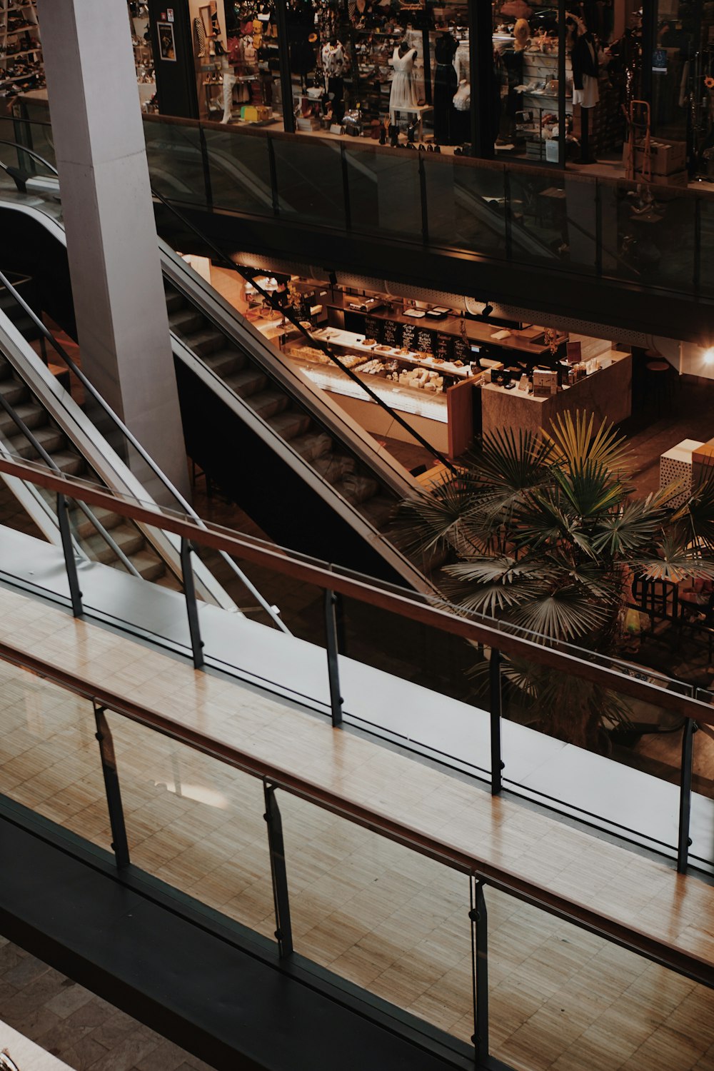 an escalator in a shopping mall with lots of people