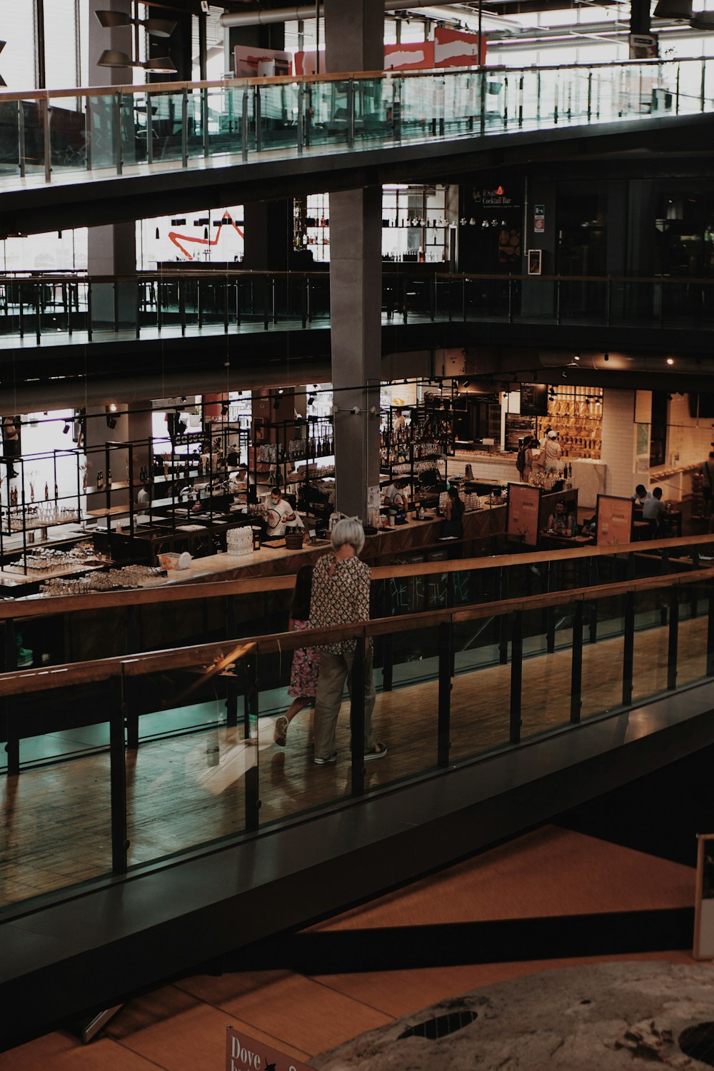 a person walking down a walkway in a building