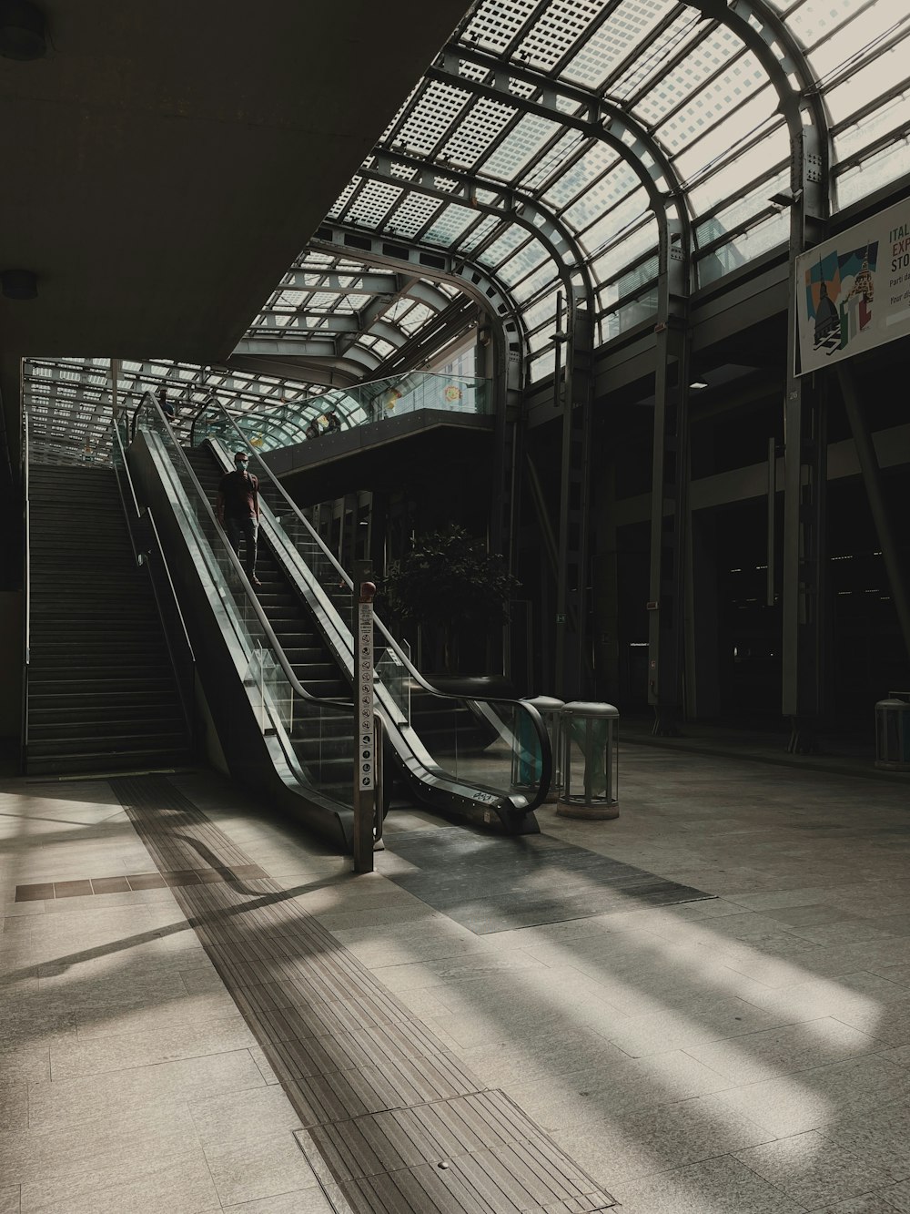 an escalator in a large building with a skylight