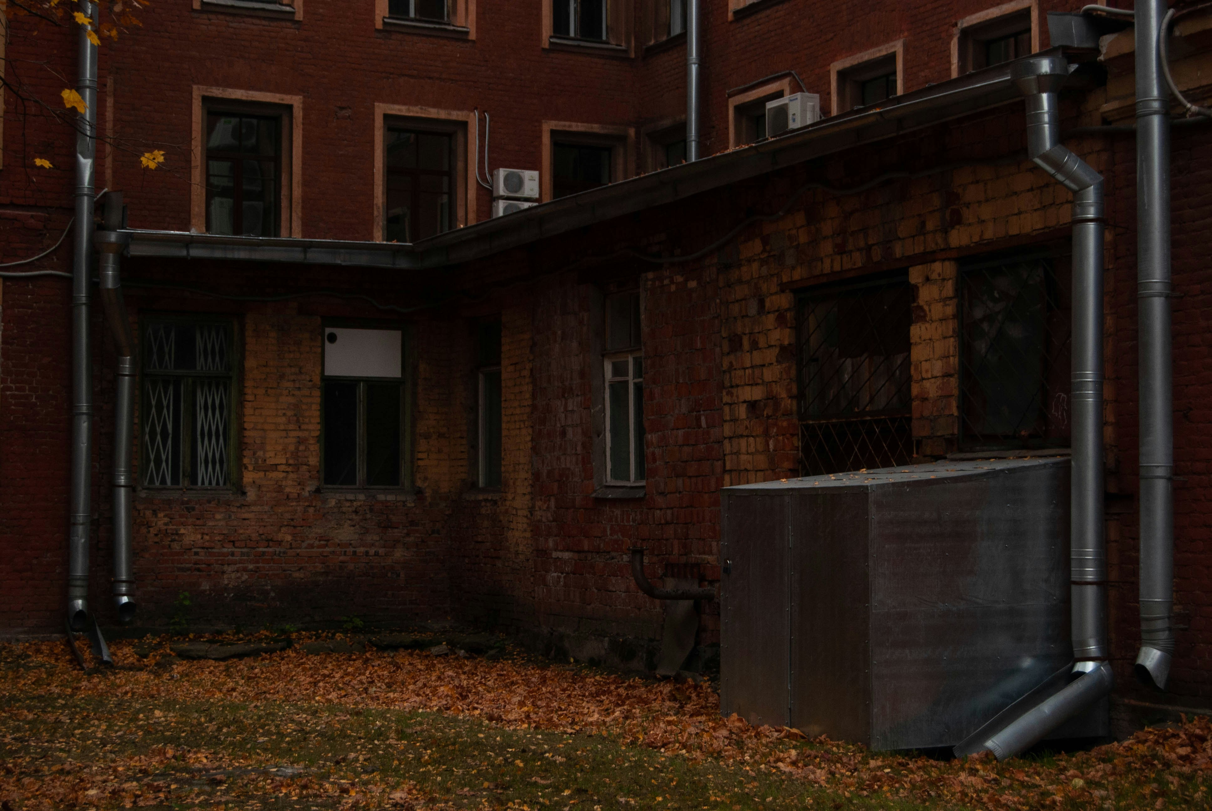Ductless mini-split outdoor unit next to an older brick home in Minneapolis - ductless mini split ac minneapolis