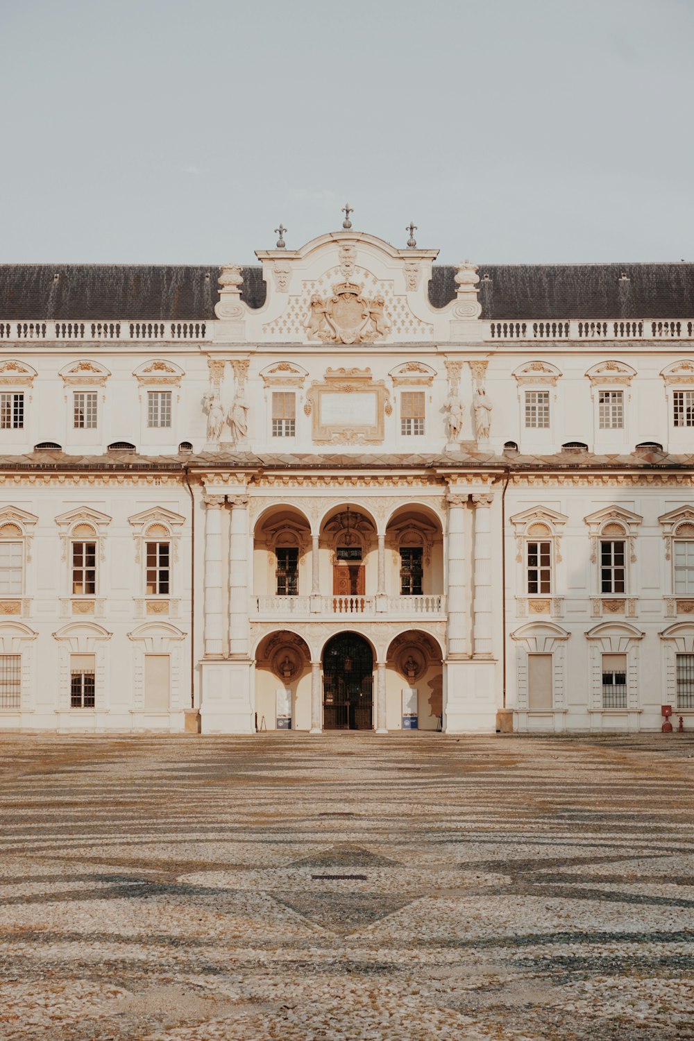 a large white building with a clock on the front of it