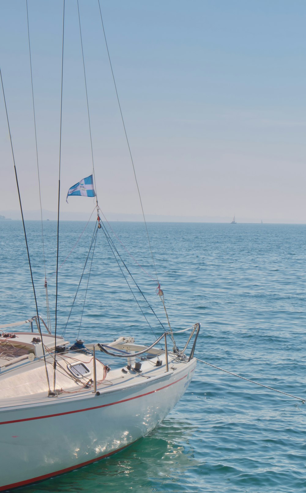 a sailboat in the water with a flag on it