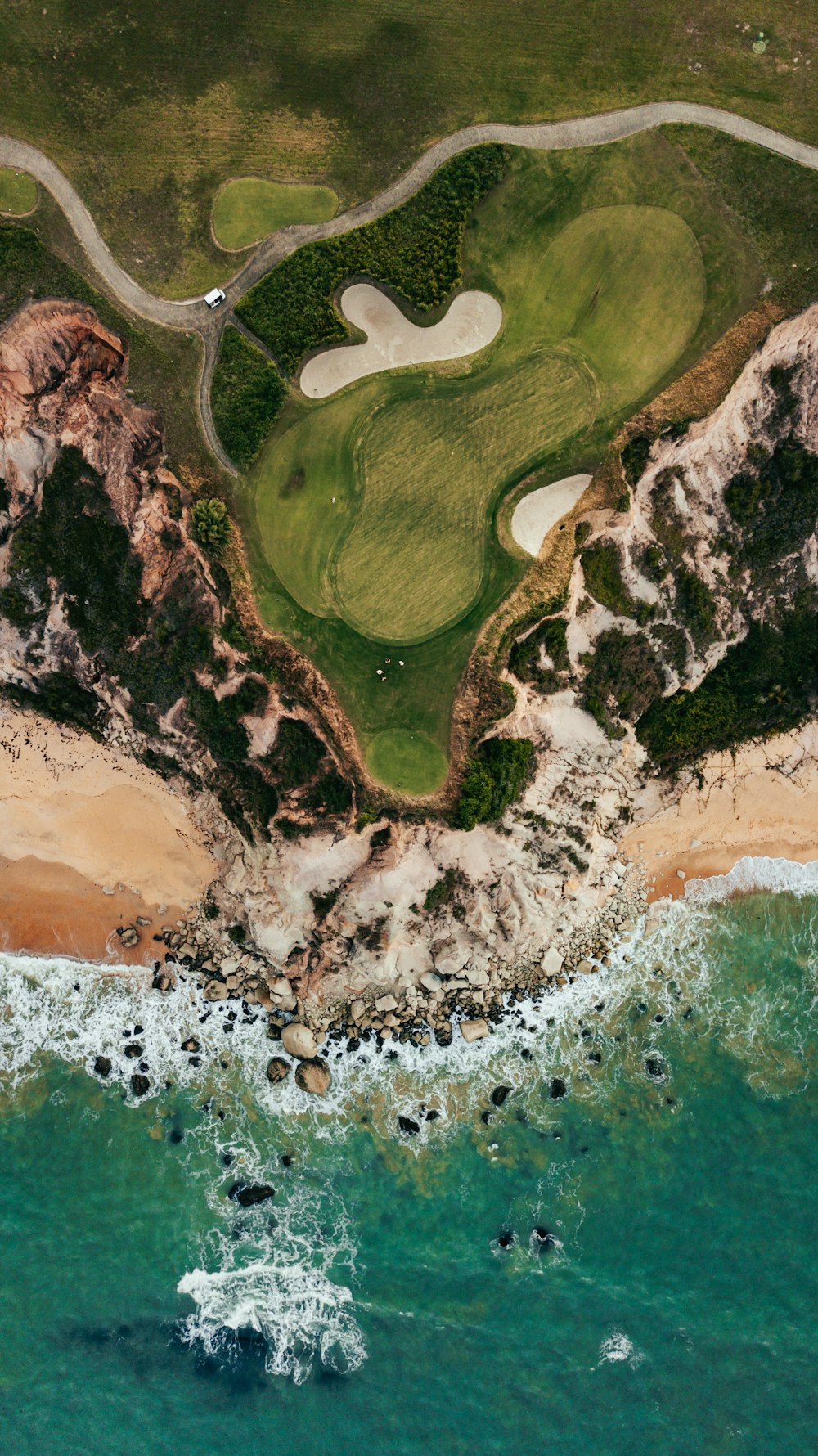 an aerial view of a golf course near the ocean