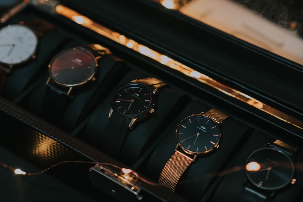 a bunch of watches sitting in a case