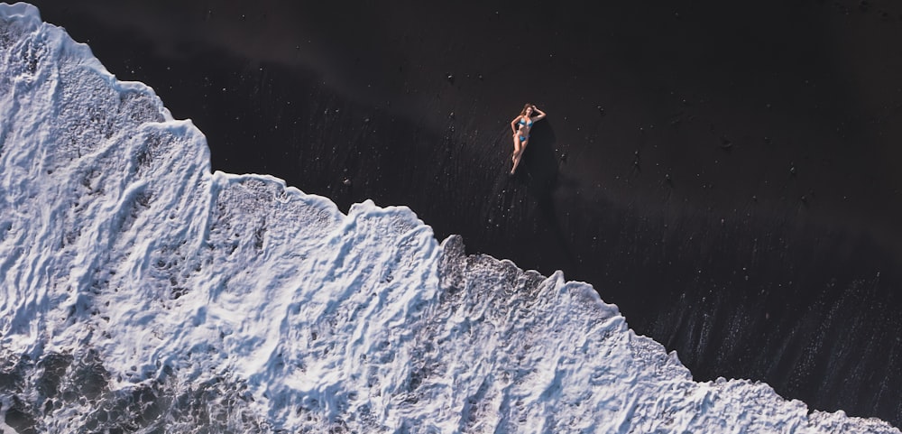 an aerial view of a person swimming in the ocean