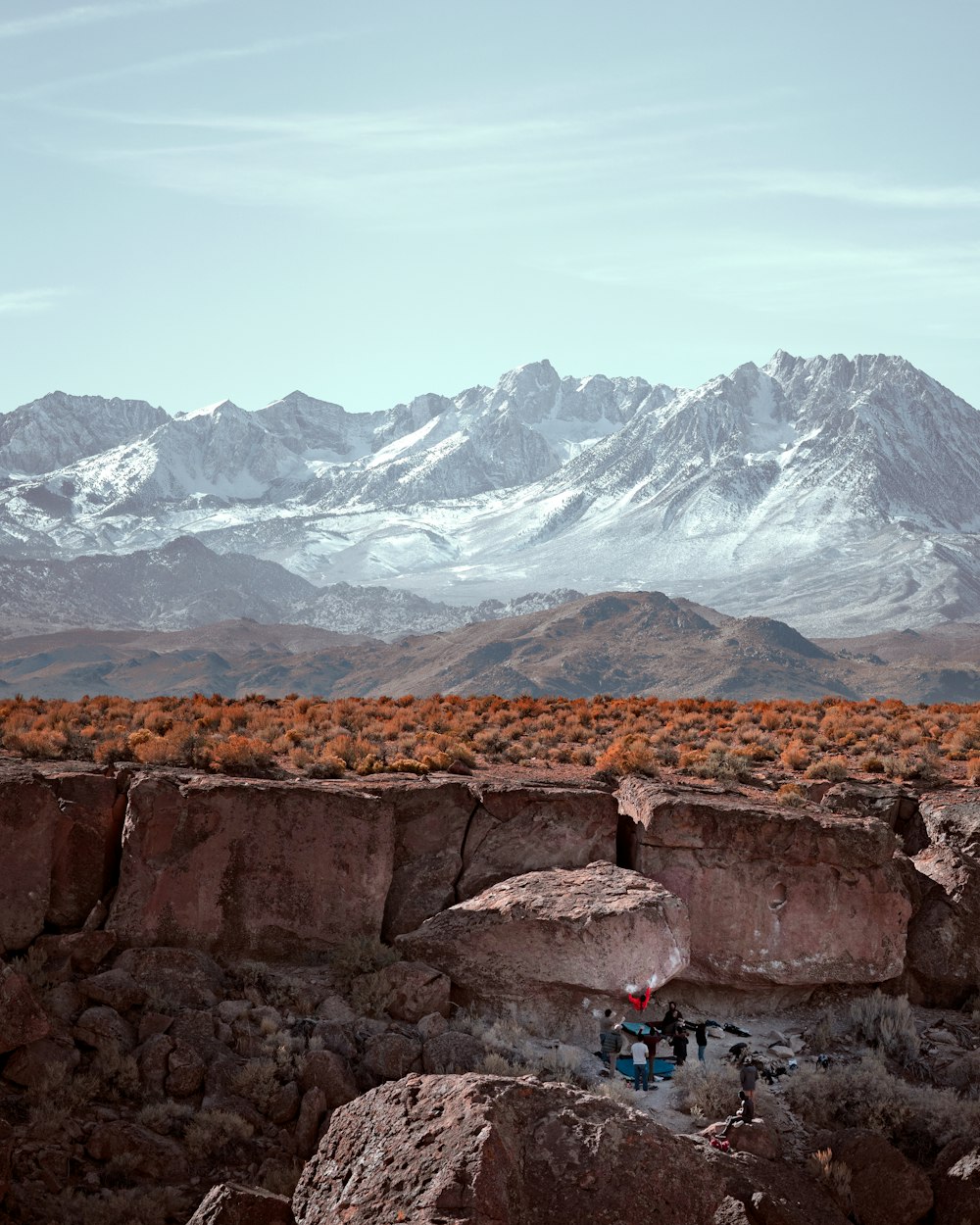 a group of people standing on top of a rocky hillside